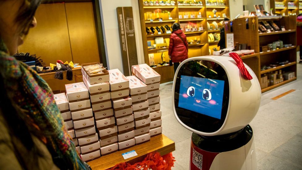 Artificial intelligence will let robots do more complicated jobs, such as this shop assistant serving customers in Japan (Credit: Getty Images)