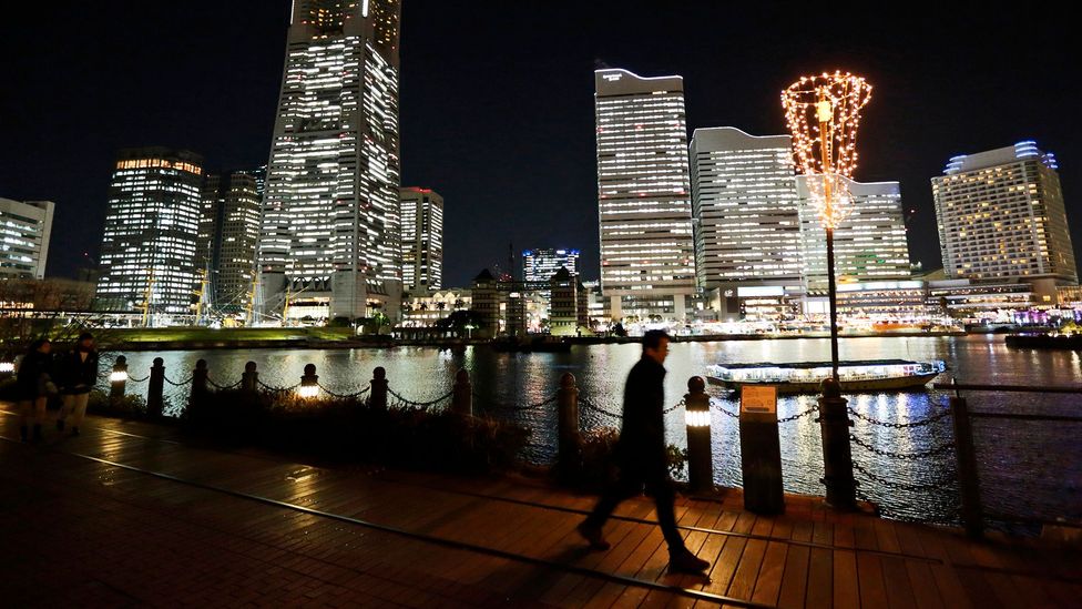 Despite the late hour and darkness, it's likely many are working inside these well-lit Tokyo buildings (Credit: Getty Images) Despite the late hour and darkness, it's likely many are working inside these well-lit Tokyo buildings (Credit: Getty Images)