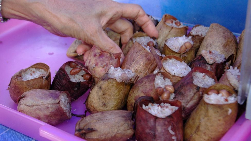 Lemang periuk kera (white rice in pitcher plants) is a popular snack in Malaysian Borneo (Credit: Jonathan Lin/Flickr)