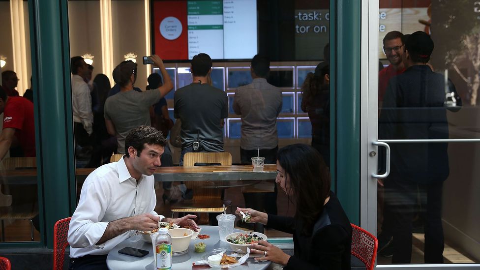 Customers dine outside Eatsa, San Francisco's first fully automated restaurant in 2015 - food is picked up in 'cubbies,' no server, wait staff or cashier required. (Credit: Getty) Customers dine outside Eatsa, San Francisco's first fully automated restaurant in 2015 - food is picked up in 'cubbies,' no server, wait staff or cashier required. (Credit: Getty)