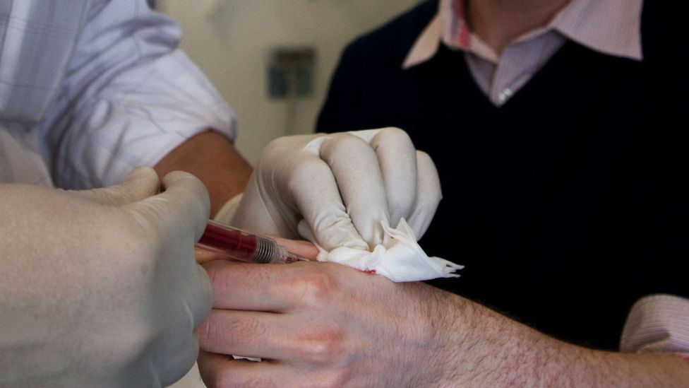 A surgeon injects the glass encased implant into Gasson's left hand (Credit: Paul Hughes) A surgeon injects the glass encased implant into Gasson's left hand (Credit: Paul Hughes)