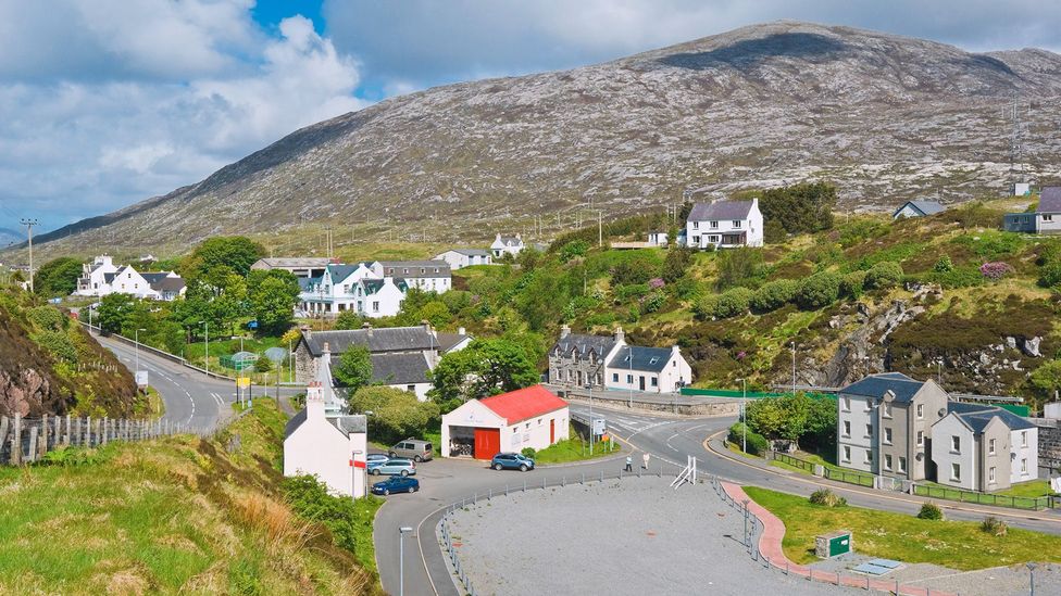 Studies have shown that living in smaller communities, like the Isle of Harris town of Tarbert (population: 500), can increase a sense of trust and belonging (Credit: Alamy)