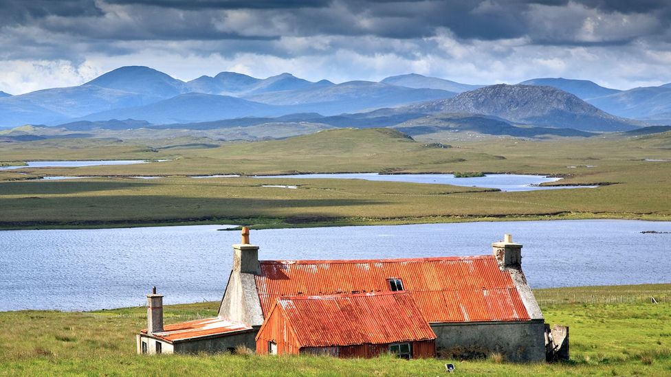 Studies show that living near the water, as at this cottage on the Isle of Lewis, is correlated with higher levels of happiness (Credit: Alamy)