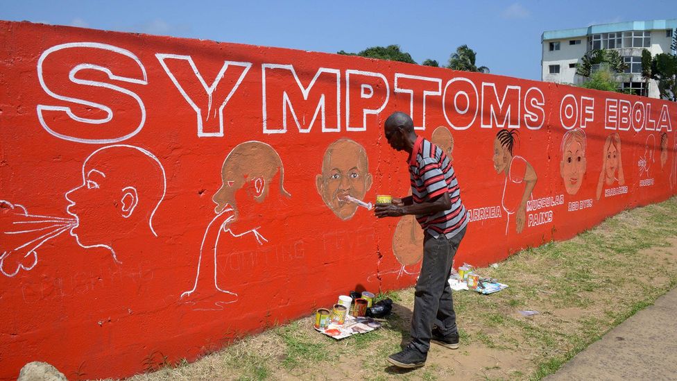 A street artist painting an educational mural about Ebola (Credit: Getty Images)