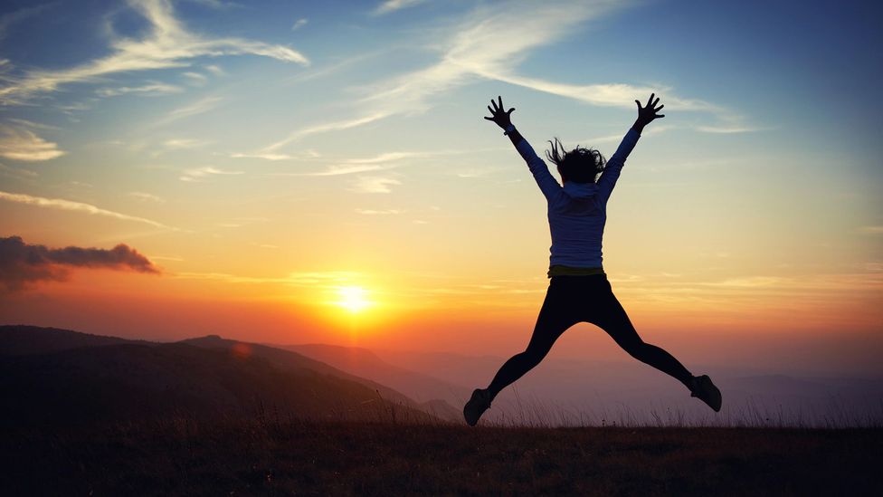 Woman jumping at sunset (Credit: Alamy)