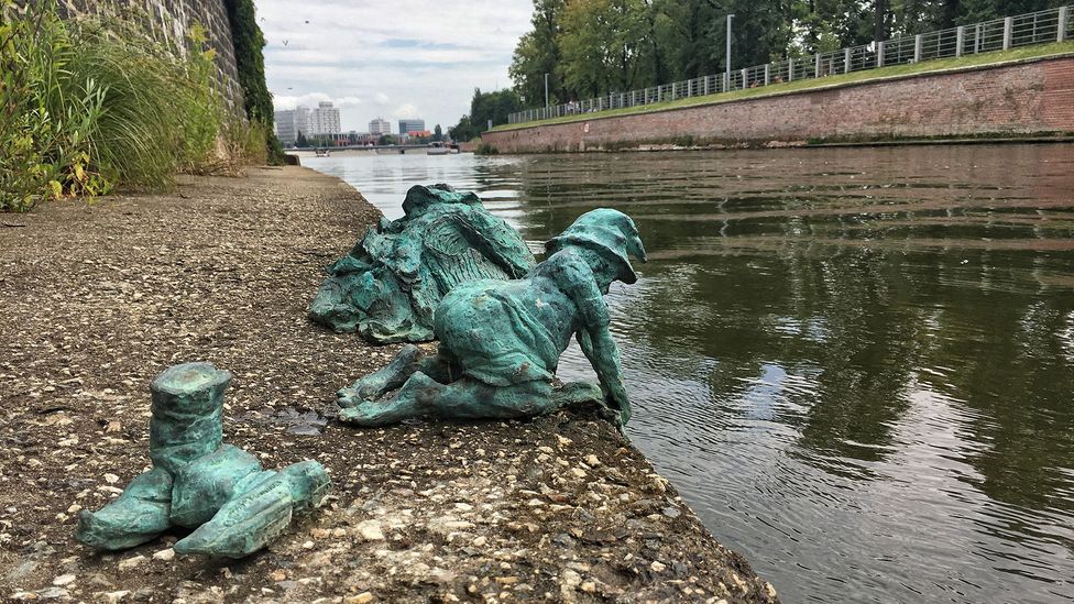 Sculptor Tomasz Moczek insists this dwarf removed his shoes because he didn’t want to get them wet while washing in the river (Credit: Eliot Stein)