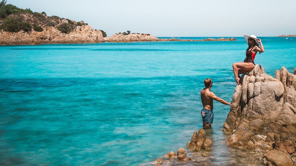 The couple enjoying the turquoise Sardinian waters at Spiaggia Del Principe in Porto Cervo, Sardinia (Credit: Scott Stohler)