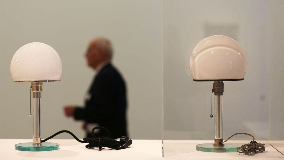 An original desk lamp by Wilhelm Wagenfeld, an iconic Bauhaus design, sits next to a modern replica in Germany's Bundeskunsthalle museum last year (Credit: Oliver Berg/DPA/Alamy)