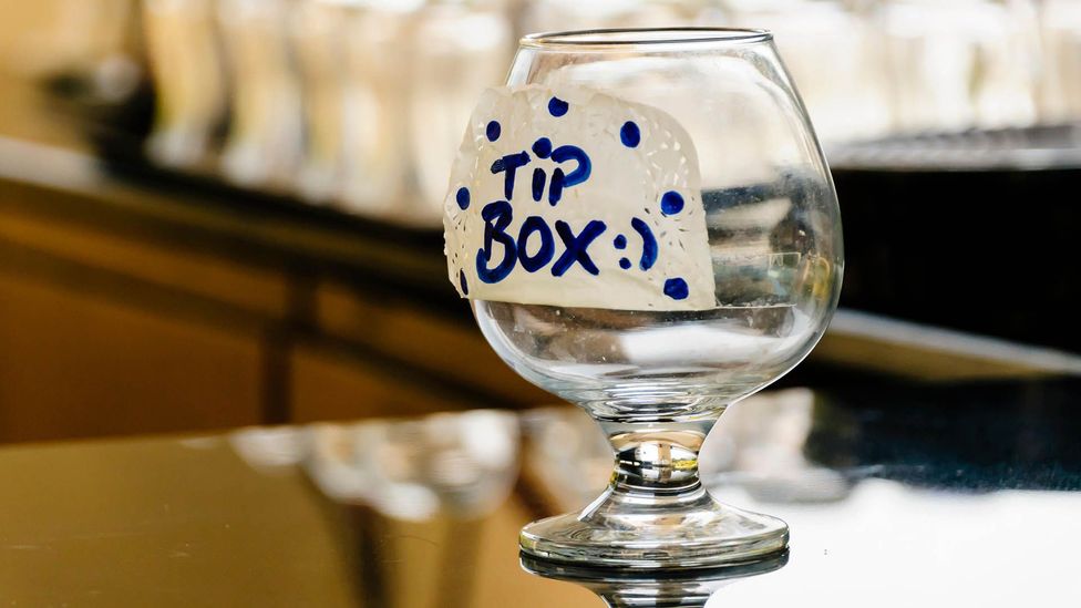 In many countries, bartenders and servers at restaurants depend on tips to earn a livable wage (Credit: Alamy) In many countries, bartenders and servers at restaurants depend on tips to earn a livable wage (Credit: Alamy)