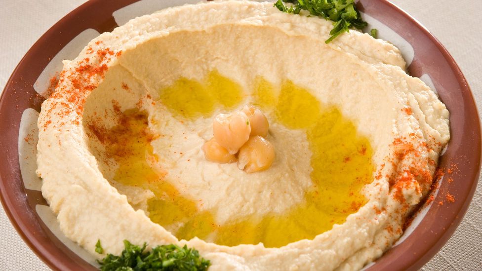 Hummus is traditionally served in a red clay bowl with a raised edge (Credit: tadphoto/Getty Images)