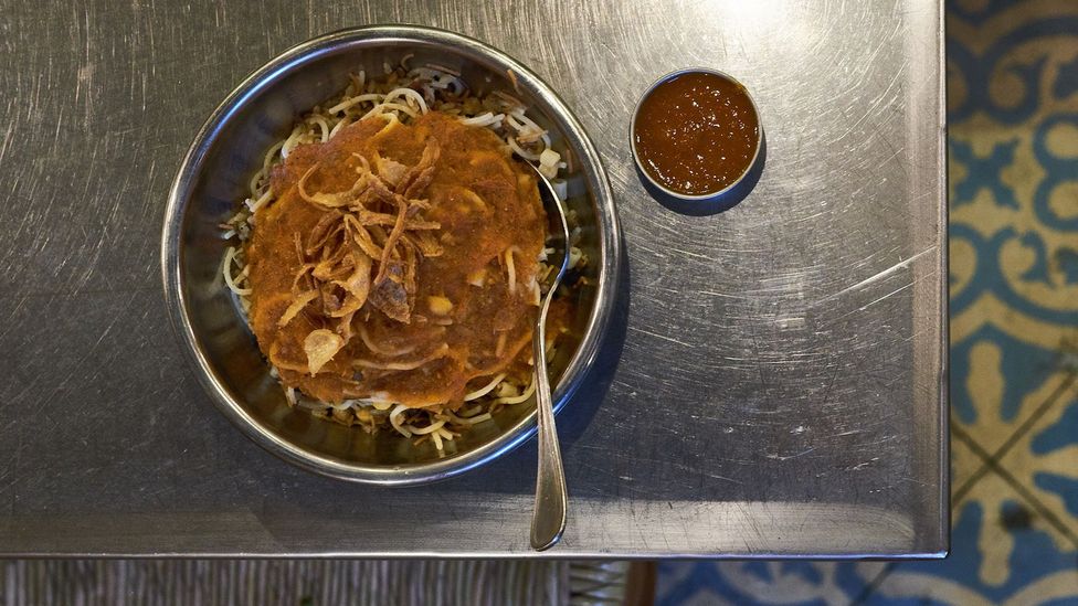Koshari, a dish made with rice, lentils, pasta, tomato sauce, chickpeas, fried onions and dukkah at a restaurant in Heliopolis’s food court (Credit: Yehia El Alaily) Koshari, a dish made with rice, lentils, pasta, tomato sauce, chickpeas, fried onions and dukkah at a restaurant in Heliopolis’s food court (Credit: Yehia El Alaily)