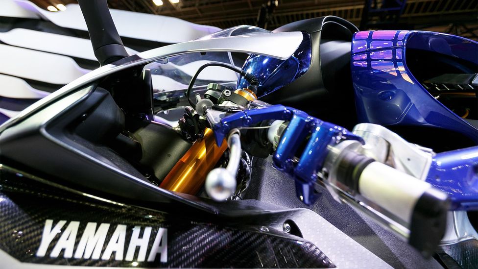 While Motobot is attached to the bike, it is required to grip and twist the throttle, as a human would (Credit: Alamy) While Motobot is attached to the bike, it is required to grip and twist the throttle, as a human would (Credit: Alamy)