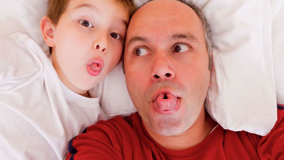 Father and son rolling tongues (Credit: Alamy)