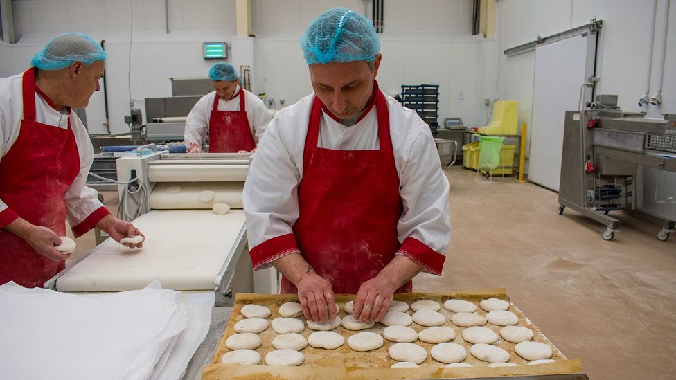 A machine flattens blaas at Walsh's Bakehouse in Waterford, while bakers finish them by hand (Credit: Amanda Ruggeri)
