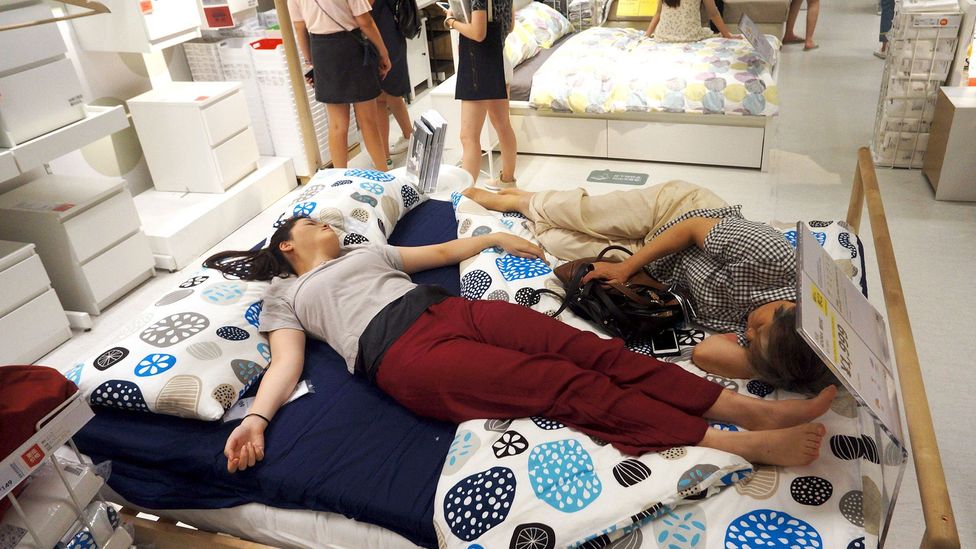 People nap on a bed at an Ikea store to escape the heat outside in Hangzhou, China, in 2017 (Credit: Getty Images) People nap on a bed at an Ikea store to escape the heat outside in Hangzhou, China, in 2017 (Credit: Getty Images)