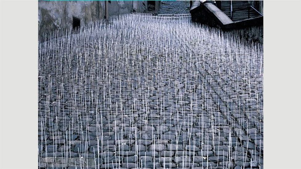 In 1981 Ivan Kafka covered a street in Prague with 1,000 upright wooden sticks – the only way people could get to work was by trampling them (Credit: Ivan Kafka/Artlist.cz)