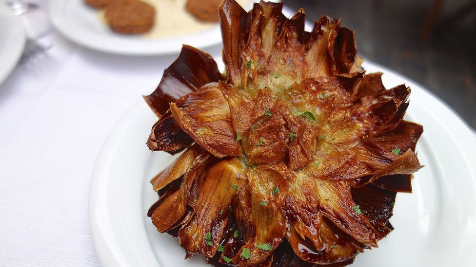 <I>Carciofi alla giudia</I>, or Jewish-style artichokes, is the most iconic dish of Roma-Jewish cuisine (Credit: Emma Lapperruque/Alamy)