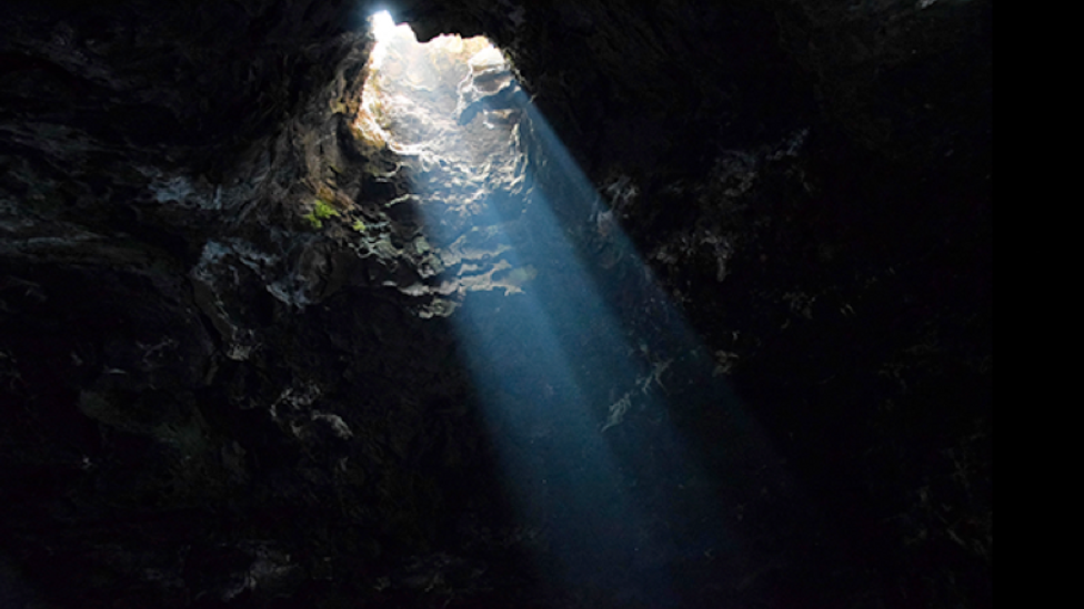 Light comes through a hole in a cavern (Credit: Alamy)