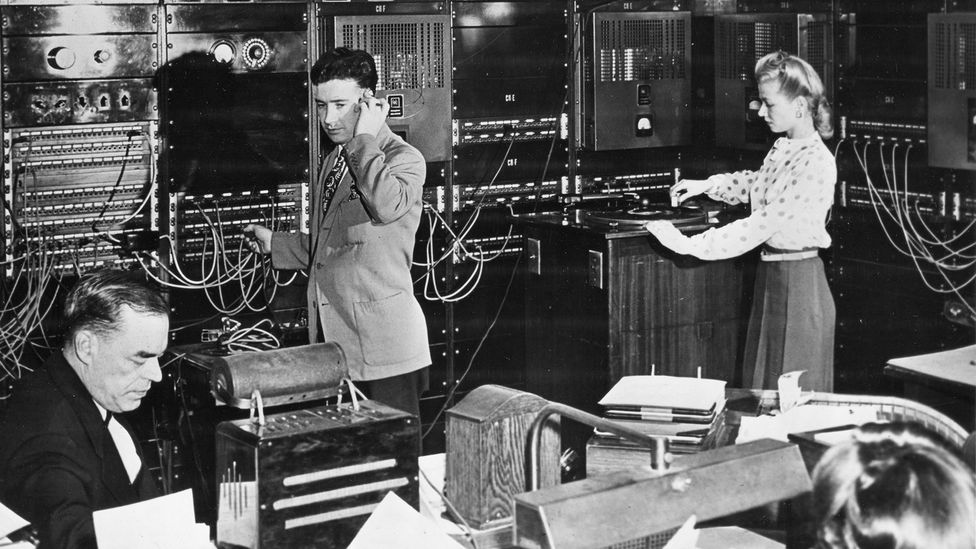Operators in the Muzak master control room monitor background music programs and make adjustments in New York in 1950 (Credit: Getty Images)