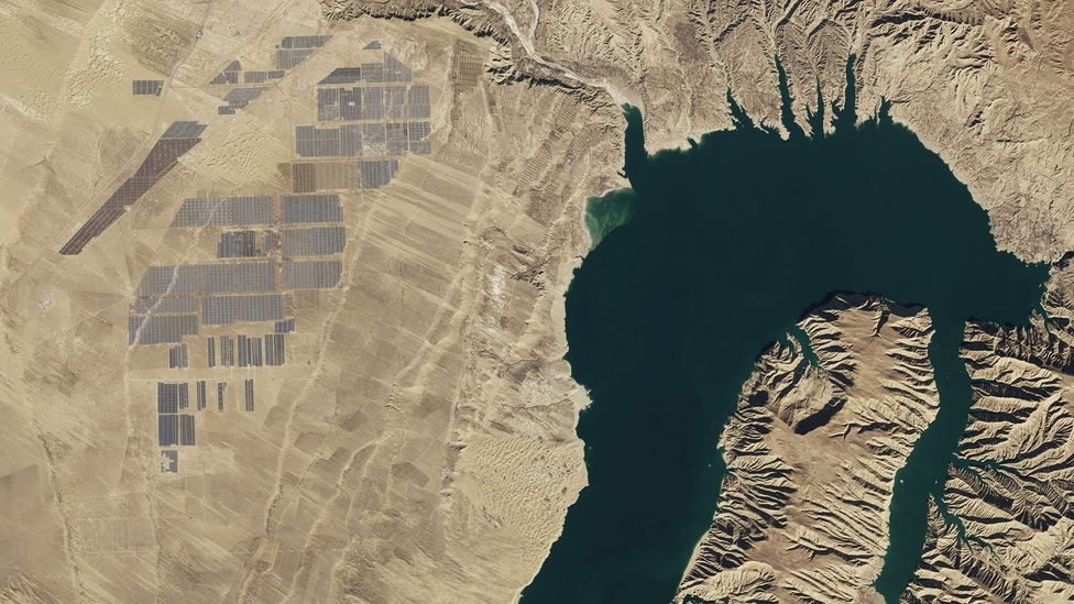 A hydroelectric dam is connected to a solar farm at Longyangxia - it is one of the largest photovoltaic power stations in the world (Credit: Nasa Earth Observatory)