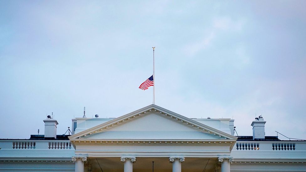 The US flag above the White House flies at half-mast (Credit: Getty Images)