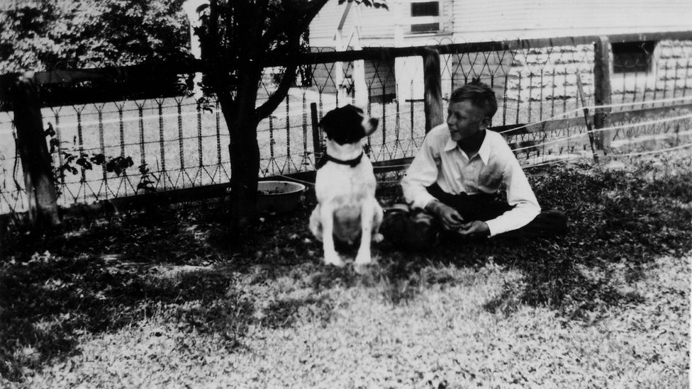 Charles Schulz and his dog Spike in 1935, when Schulz was 13 years old (Credit: Schulz Family Intellectual Property Trust/Courtesy the Charles M Schulz Museum and Research Center)