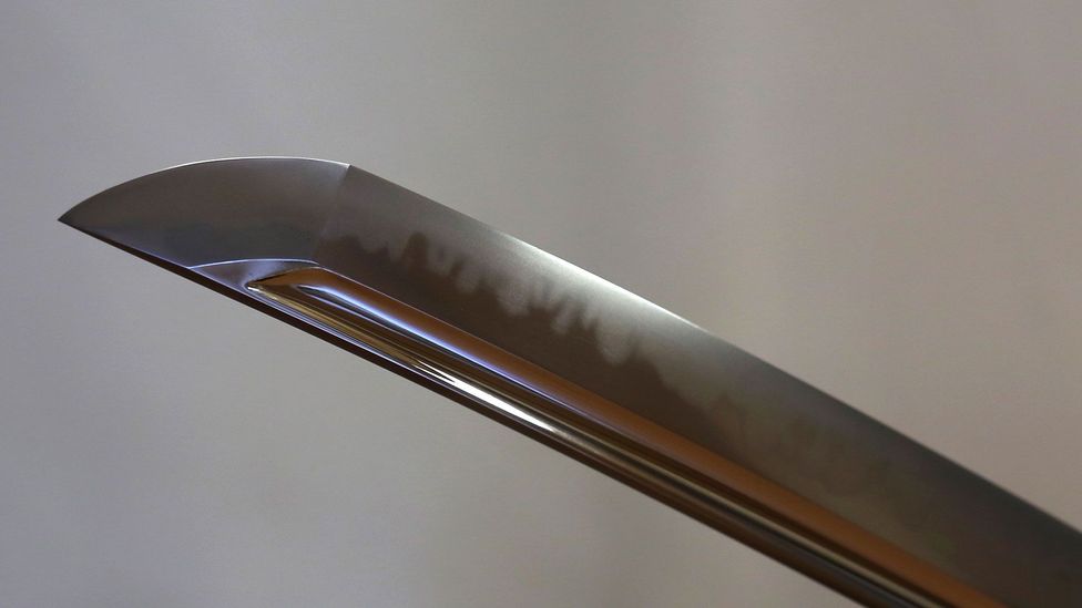 The dark line down the middle of the blade represents the point at which the harder steel on the edge meets the softer steel on the spine (Credit: Getty Images) The dark line down the middle of the blade represents the point at which the harder steel on the edge meets the softer steel on the spine (Credit: Getty Images)