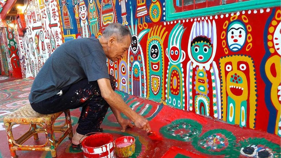 Tourists exploring the playful and colorful essence of Huang Yung-Fu's Rainbow Village