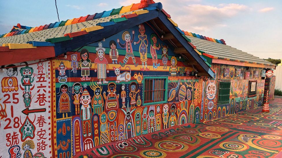 Huang Yung-Fu with his colorful artwork in Rainbow Village