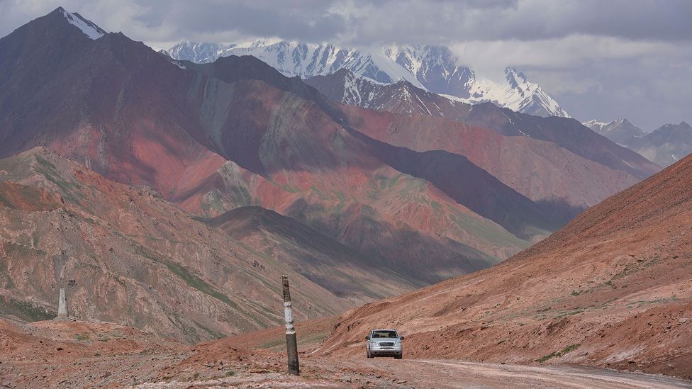 A car drives along the Pamir Highway in Tajikistan