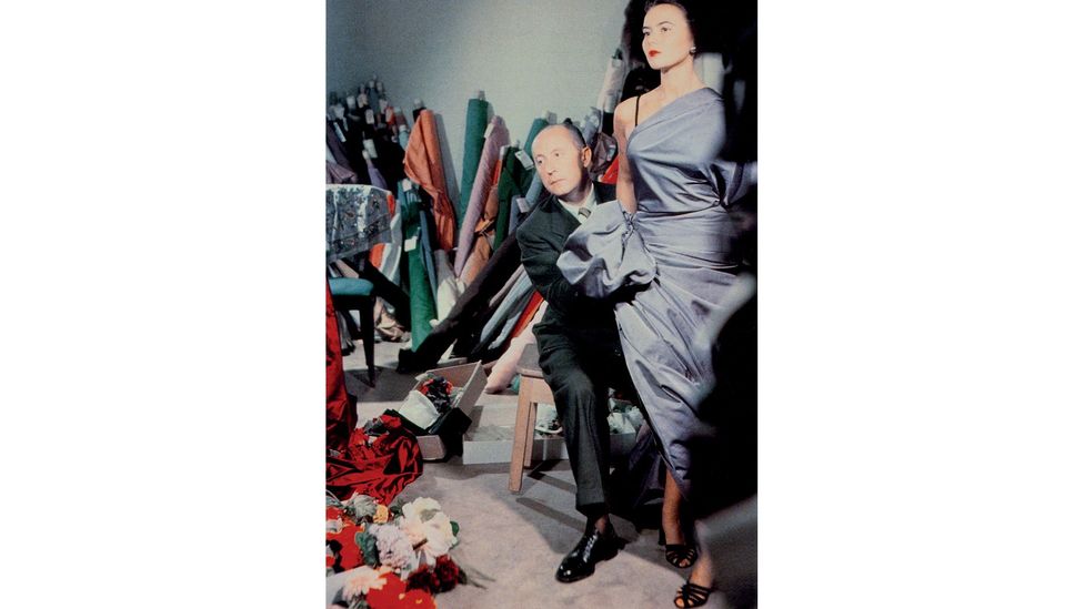 Christian Dior in his studio with one of his models – he said his work was ‘dedicated to the beauty of the female body’ (Credit: V&A London)