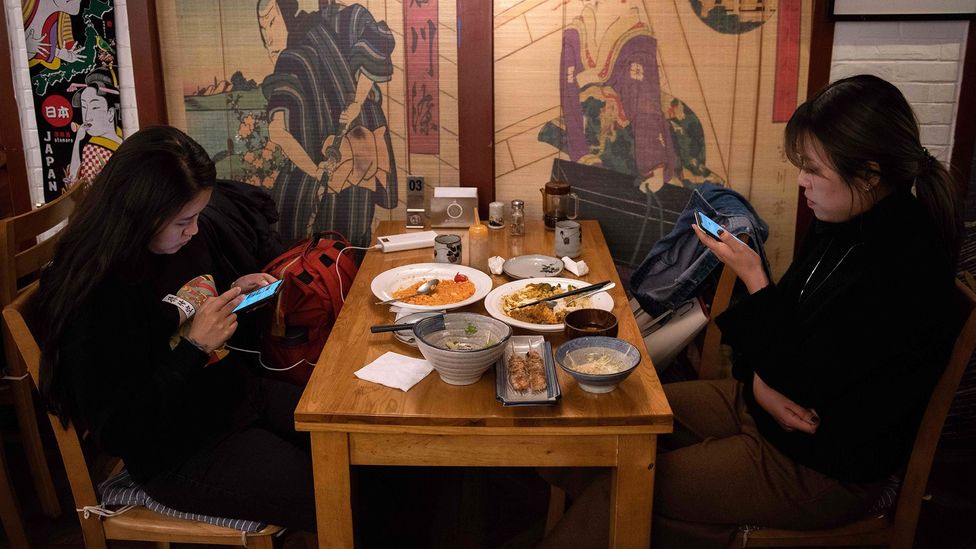 ‘When people look at their devices during their meal, instead of talking to each other while they eat, they lose so much of the multi-sensuous aspects of food’ (Credit: Getty)