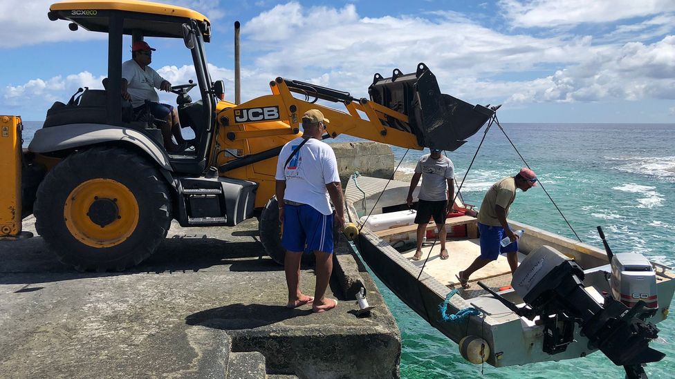 A front-loading tractor must use steel cables to raise and lower boats into the surf (Credit: Andrew Evans)