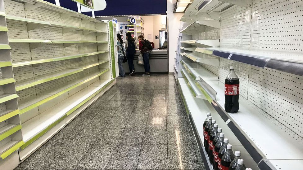 Political instability and skyrocketing inflation have led to empty shelves in shops in the capital of Venezuela (Credit: Getty Images)