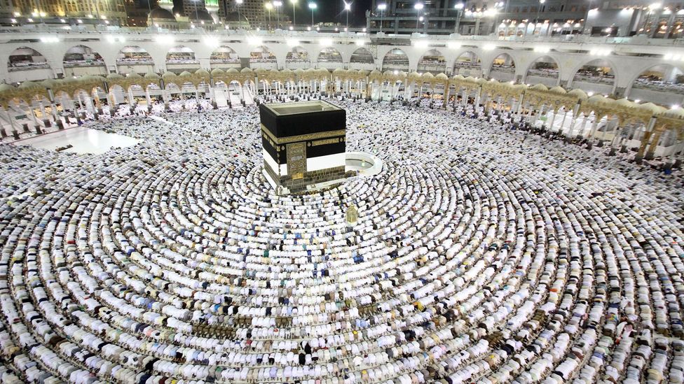 Muslim worshippers perform the evening (Isha) prayers at the Kaaba. Emotions such as awe, loyalty, and love are central to many religious celebrations (Credit: Getty)