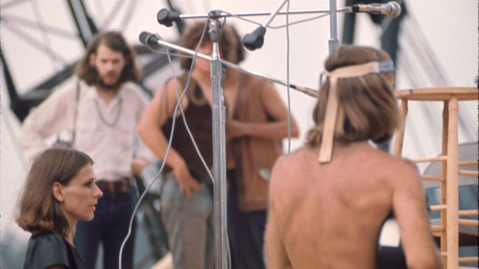 Filmmaker Michael Wadleigh (shirtless, right) and his wife and film crew member Renee Wadleigh (left) filming at Woodstock (Credit: Getty Images)