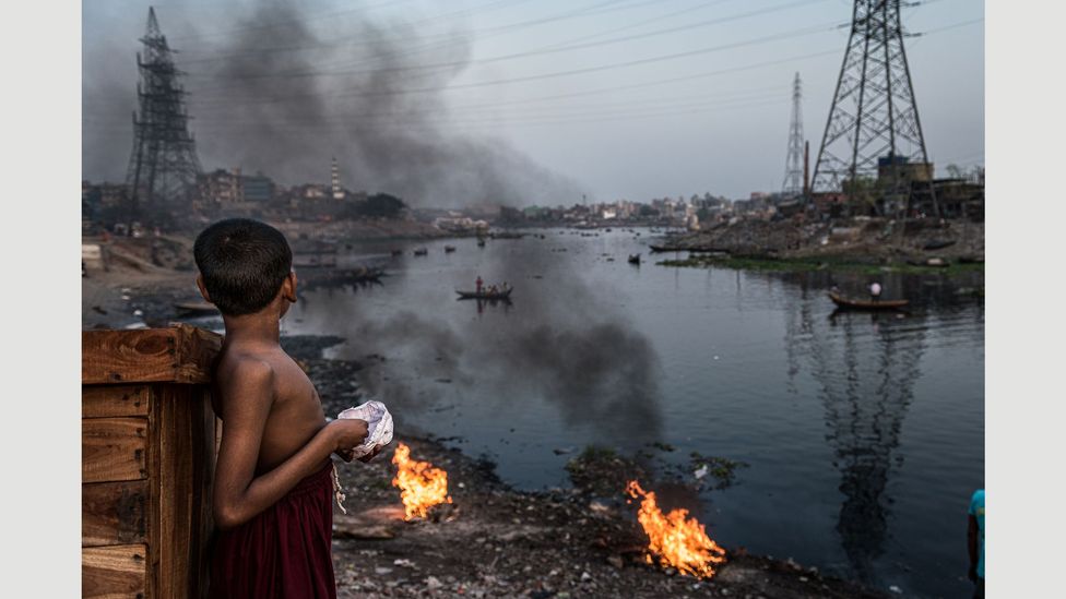 A child looks over the polluted Buriganga river that flows through slums in southwest Dhaka (Credit: Ignacio Marin/ Institute) A child looks over the polluted Buriganga river that flows through slums in southwest Dhaka (Credit: Ignacio Marin/ Institute)