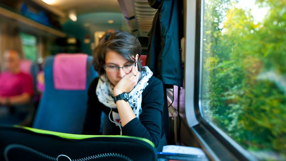 woman commuter train laptop