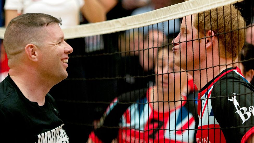 Prince Harry exchanging some friendly trash talk with a soldier during a volleyball game to support wounded service members (Credit: Alamy)