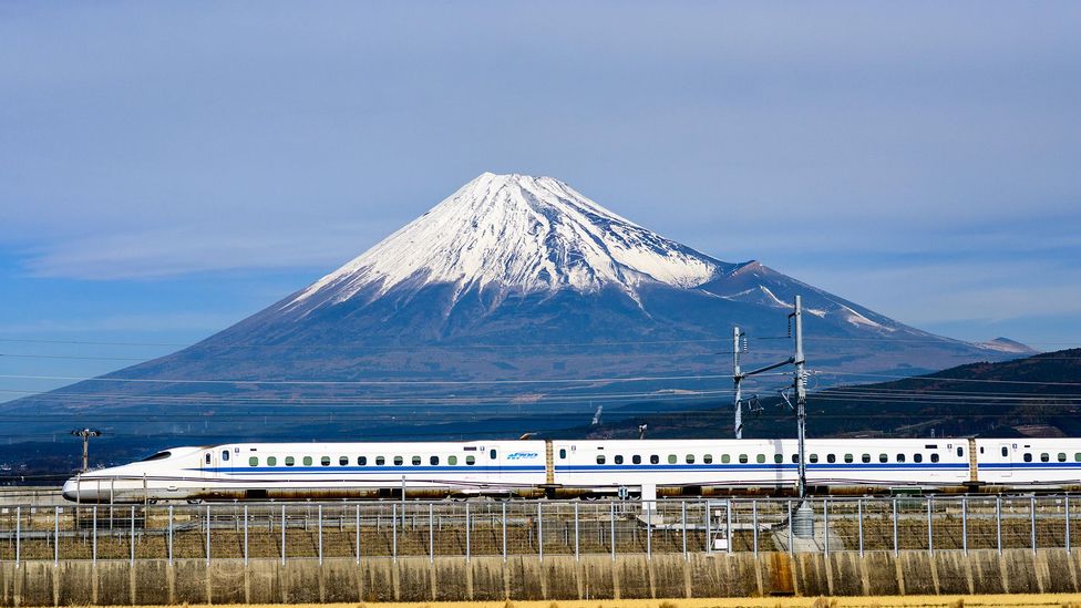 A Shinkansen bullet train passes below Mt. Fuji in Japan (Sean Pavone / Alamy Stock Photo)