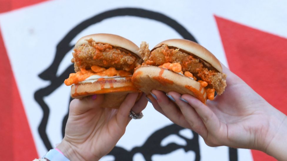 Earlier this year, KFC introduced a fried chicken sandwich that's stuffed with Cheetos, a popular, crispy, cheesy, processed snack food (Credit: Getty Images)