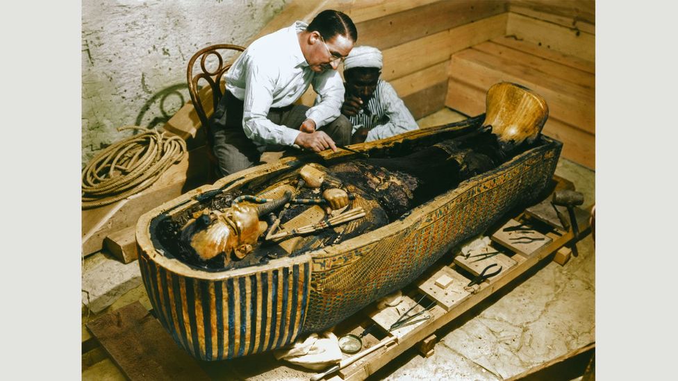 29-30 October 1925: Carter and an Egyptian workman examine the third (innermost) coffin made of solid gold, inside the case of the second coffin
