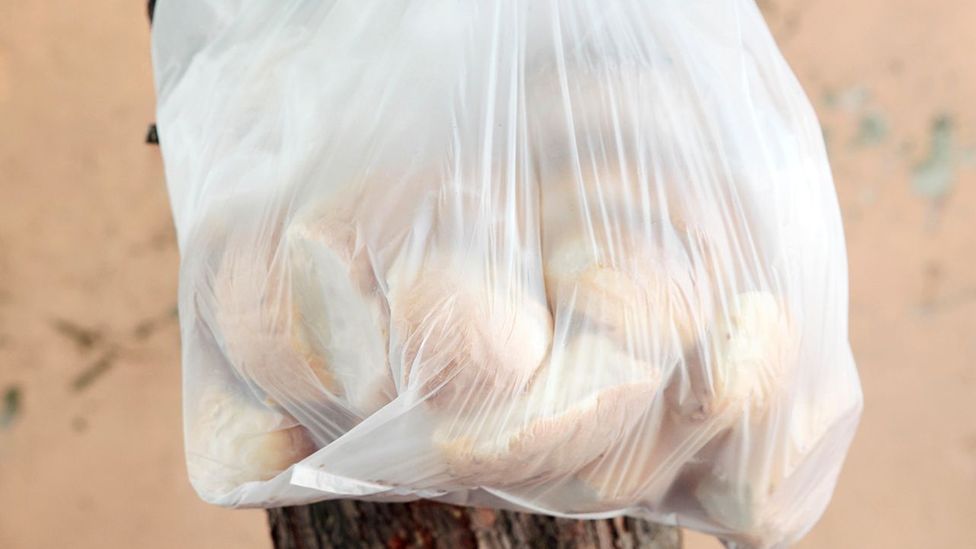 Plastic bags containing old bread are often hung on old fences for people to take (Credit: EggImages/Alamy)