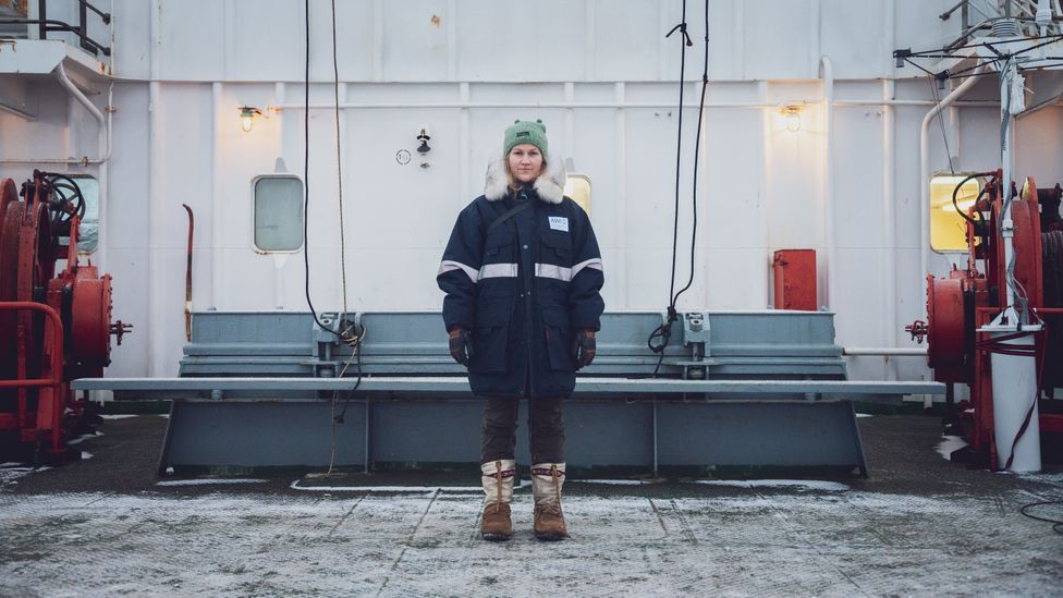 A polar bear guard stands in Arctic clothing on a ship (Credit: Thea Schneider)