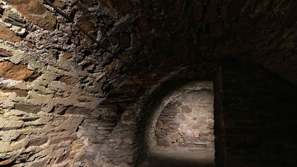 The dark, vaulted basement below the Royal Mint House is where the first thalers were assayed (Credit: Eliot Stein) The dark, vaulted basement below the Royal Mint House is where the first thalers were assayed (Credit: Eliot Stein)