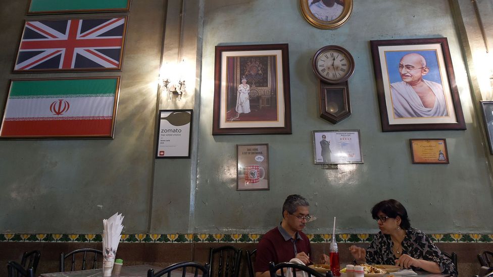 Britannia & Co Restaurant, with its Union Jack flag and image of Queen Elizabeth II, is one of Mumbai's most famous Irani cafes (Credit: Indranil Mukherjee/Getty Images) Britannia & Co Restaurant, with its Union Jack flag and image of Queen Elizabeth II, is one of Mumbai's most famous Irani cafes (Credit: Indranil Mukherjee/Getty Images)