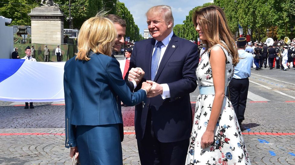Donald Trump and Emmanuel Macron's National Day Parade handshake turned into a bizarre three-way hand clasp (Credit: Getty Image)