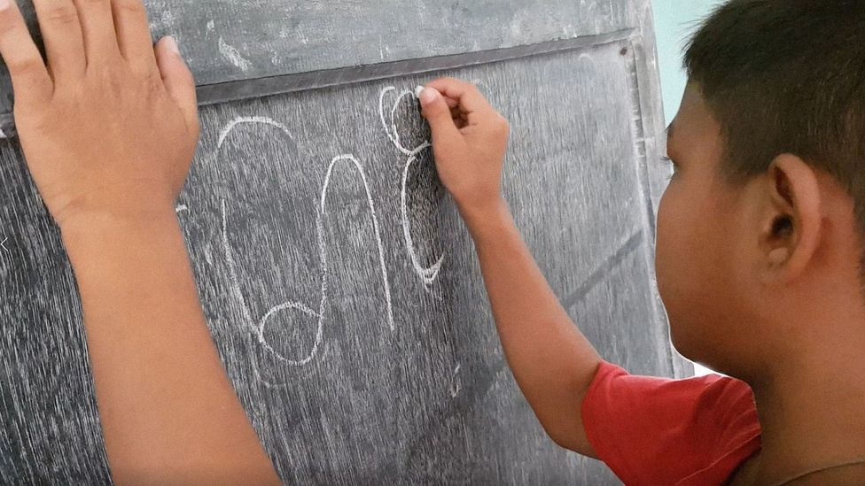 A student writes in Marma in one of Maung Nyeu’s classes, which have reached more than 3,000 children (Credit: Maung Nyeu)