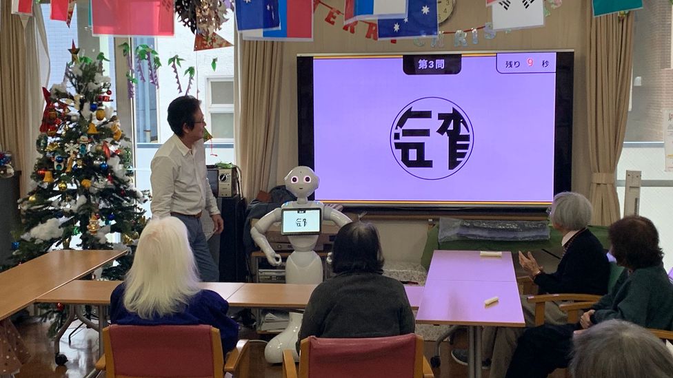 Pepper, a robot created by tech giant Softbank first released in 2015, leads a game in a nursing home. Such robots still aren't commonplace, however (Credit: Bryan Lufkin)