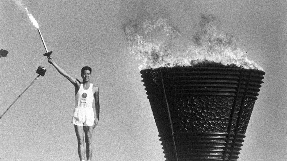 At the 1964 Tokyo Olympics, the Olympic flame - carried by Yoshinori Sakai - was a symbol of Japan's postwar reconstruction (credit: Alamy) At the 1964 Tokyo Olympics, the Olympic flame - carried by Yoshinori Sakai - was a symbol of Japan's postwar reconstruction (credit: Alamy)